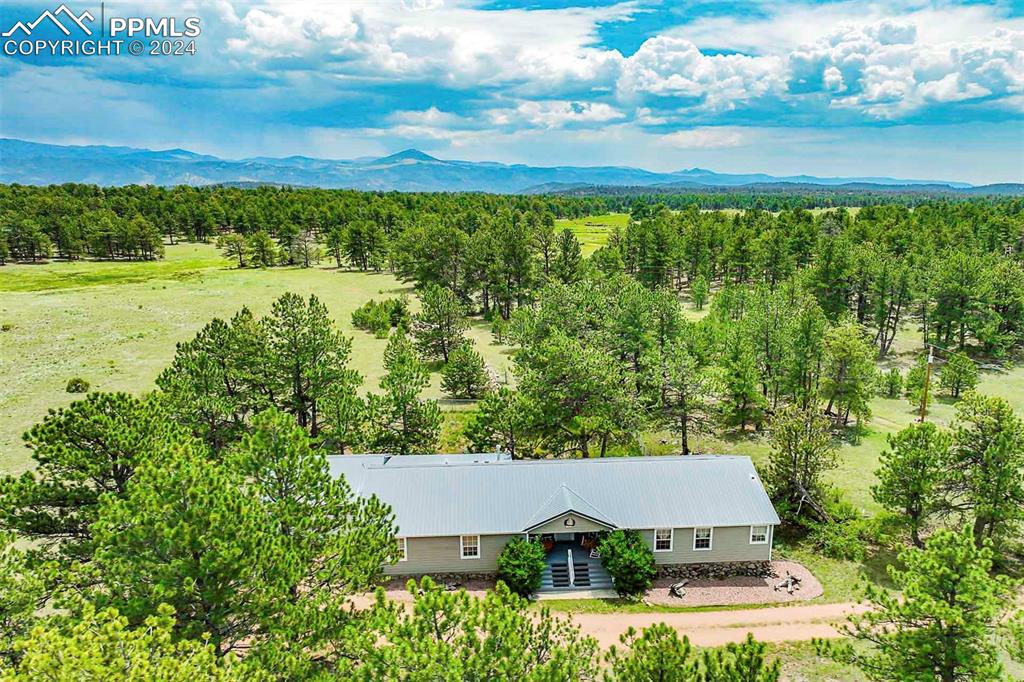 an aerial view of a house with a yard