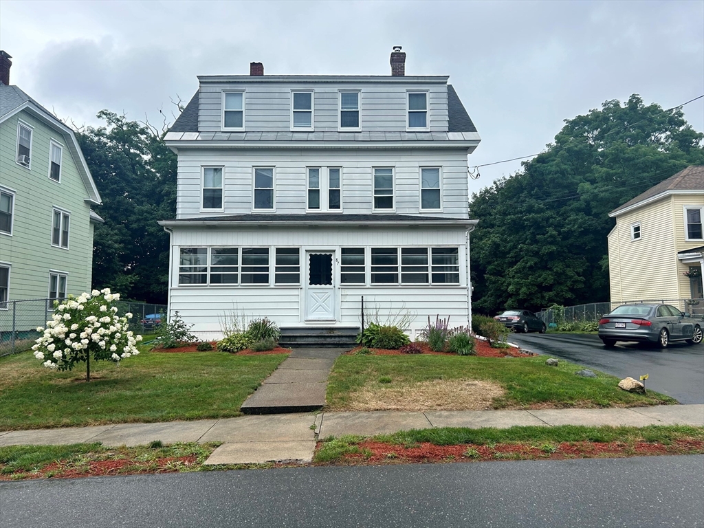 a front view of a house with a garden