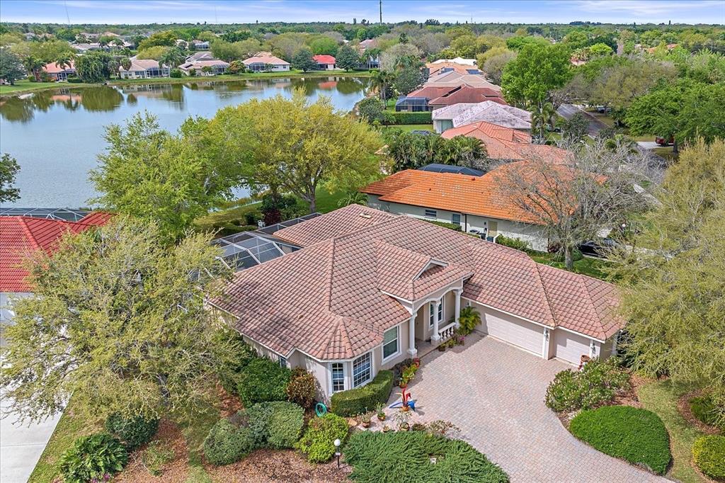 an aerial view of house with yard and lake view