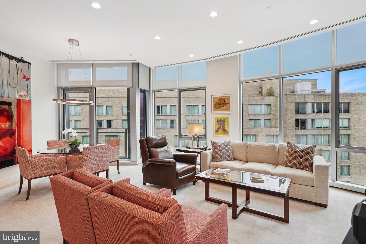 a living room with furniture city view and large windows