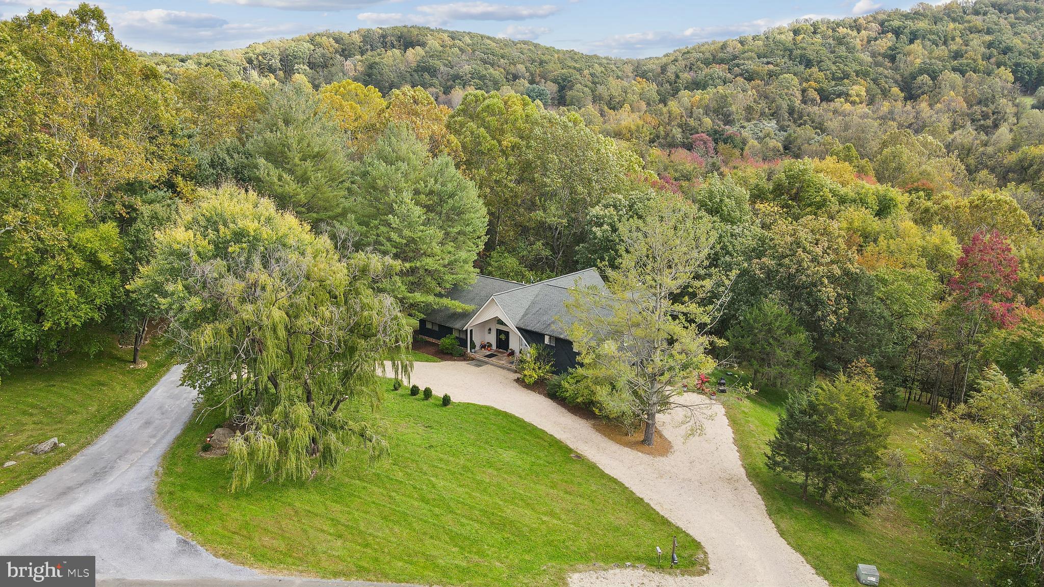 an aerial view of a house with a yard and lake view