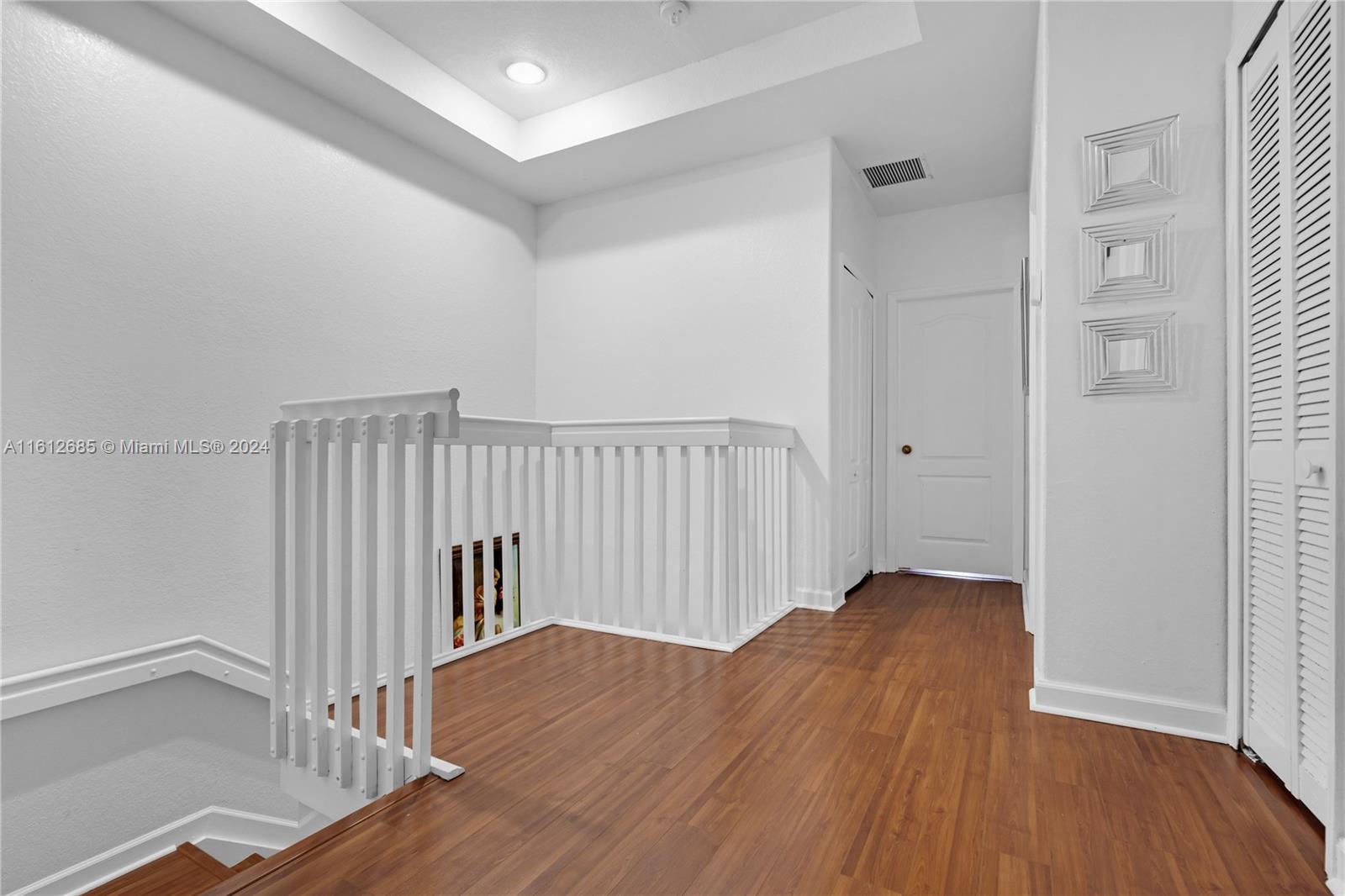 a view of hallway with wooden floor