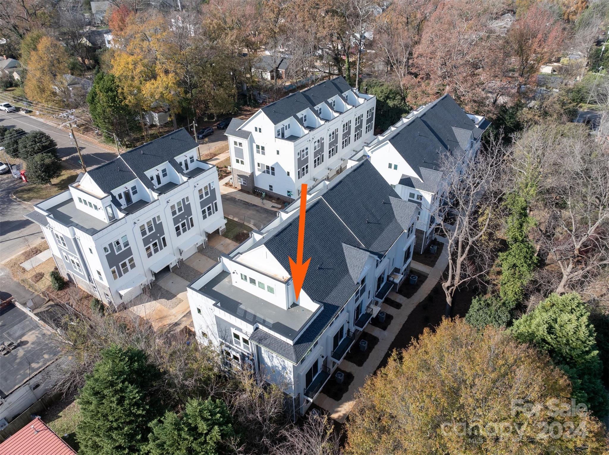 an aerial view of multiple houses with yard