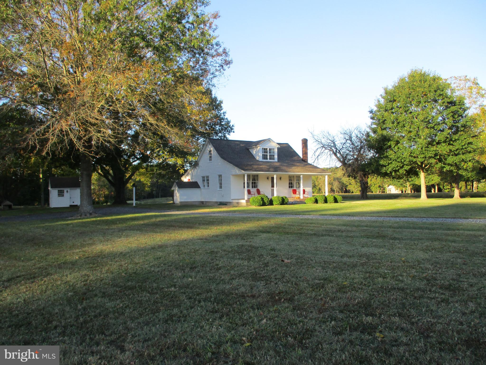 a front view of a house with a big yard