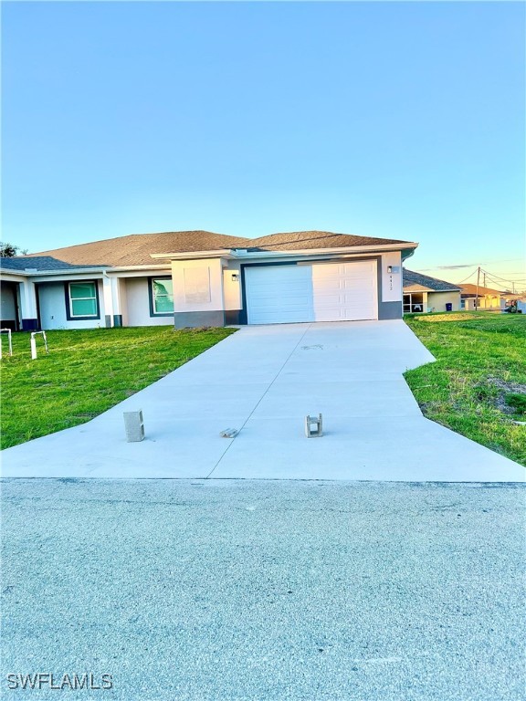 a view of a house with a yard and garage