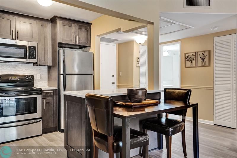 a kitchen with a refrigerator stove and microwave