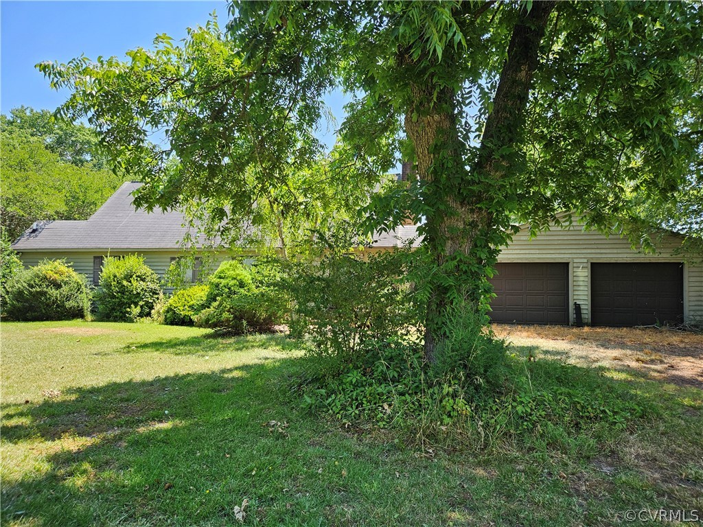 a view of a house with a yard and sitting area