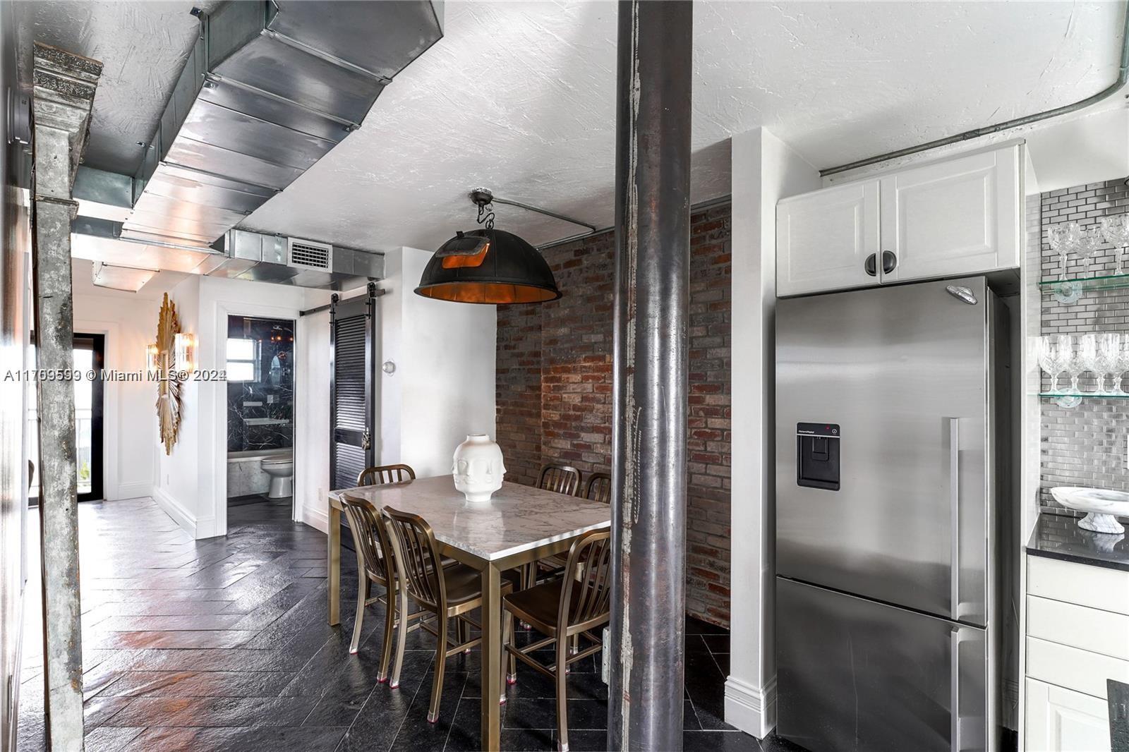 a kitchen with stainless steel appliances a refrigerator and wooden floor