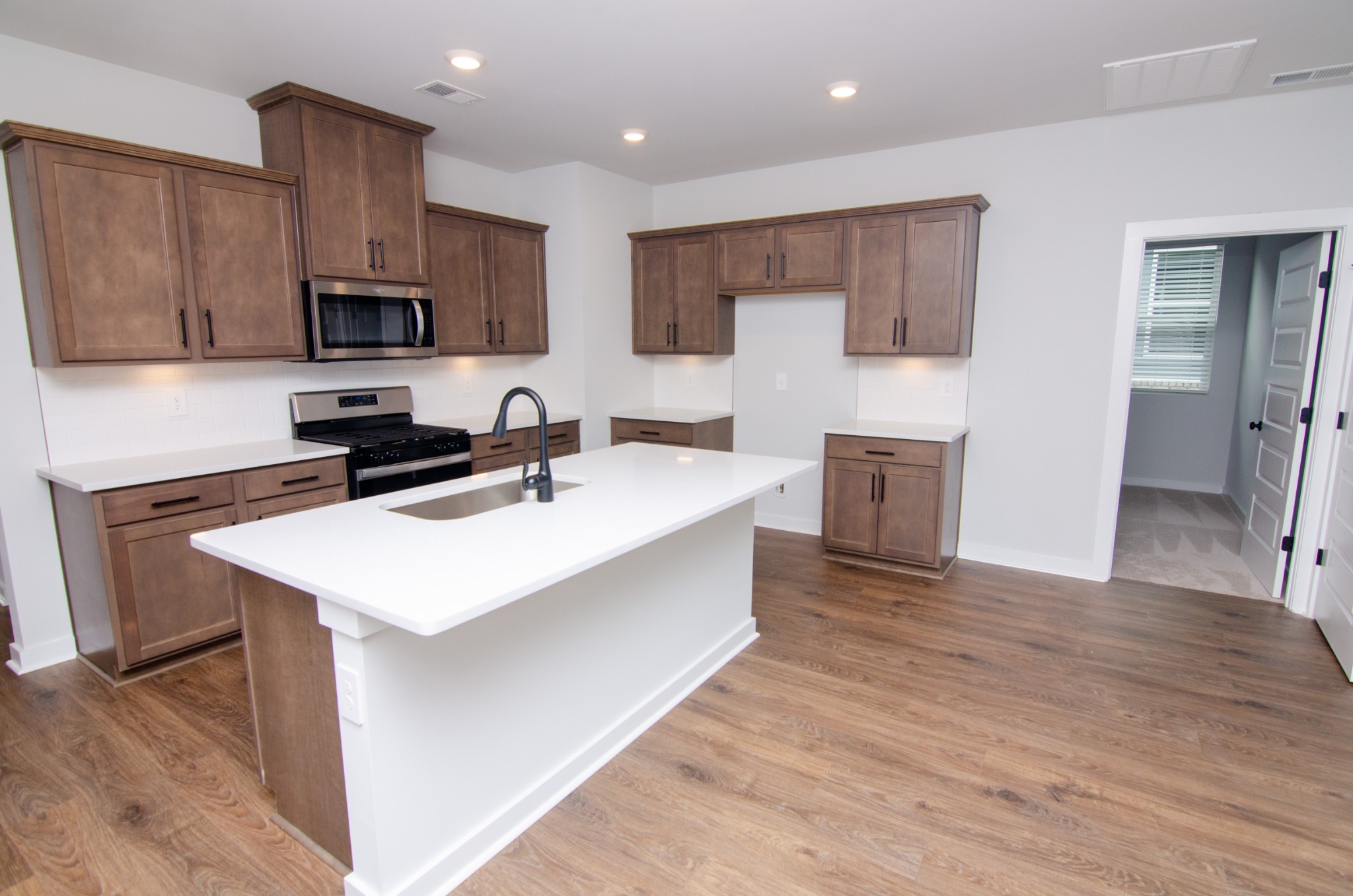 a kitchen with stainless steel appliances a sink stove and refrigerator