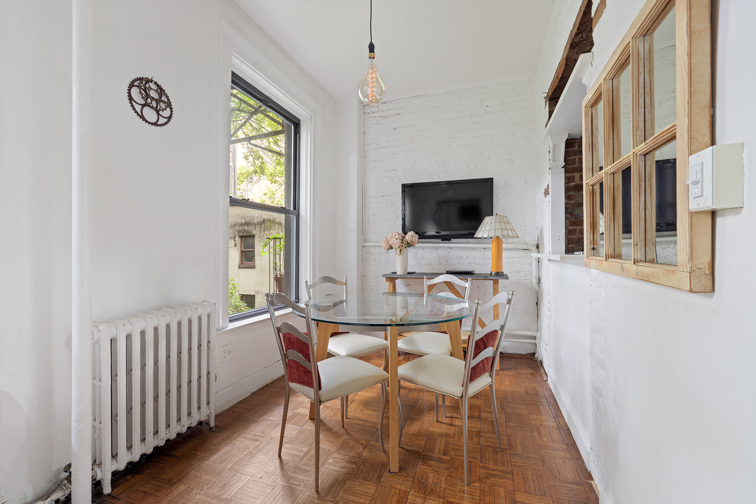 a view of a dining room with furniture window and wooden floor