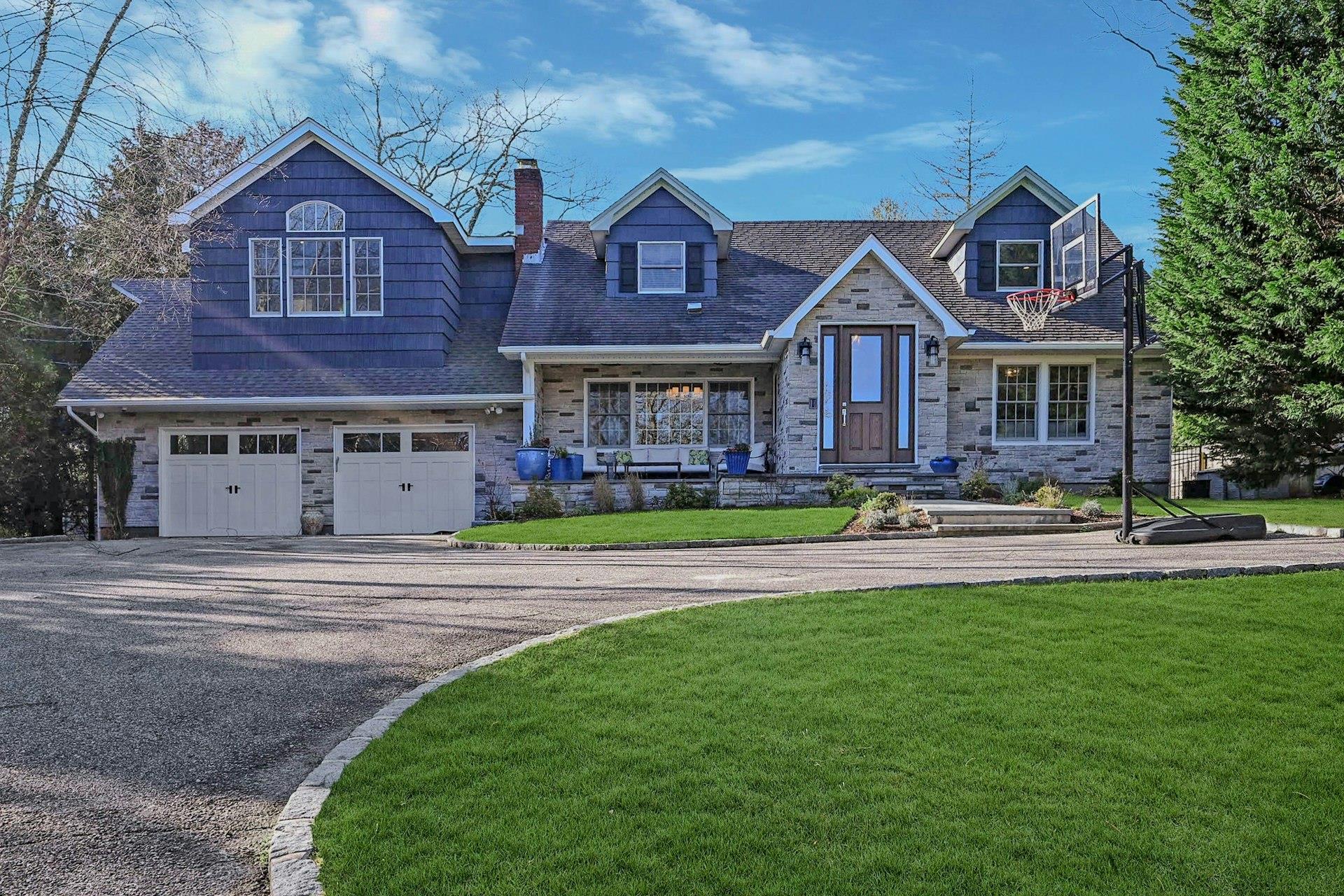 View of front of house with a front lawn and a garage