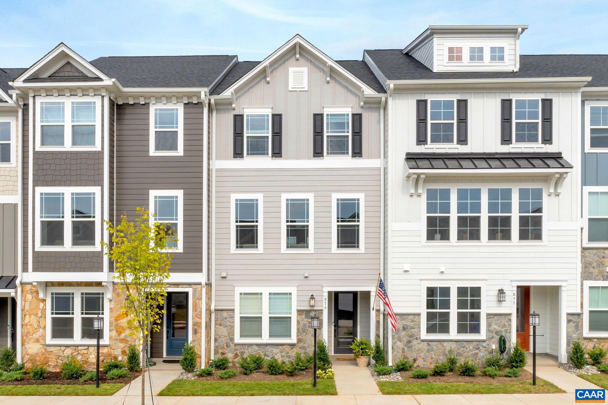 a front view of a residential apartment building with a yard