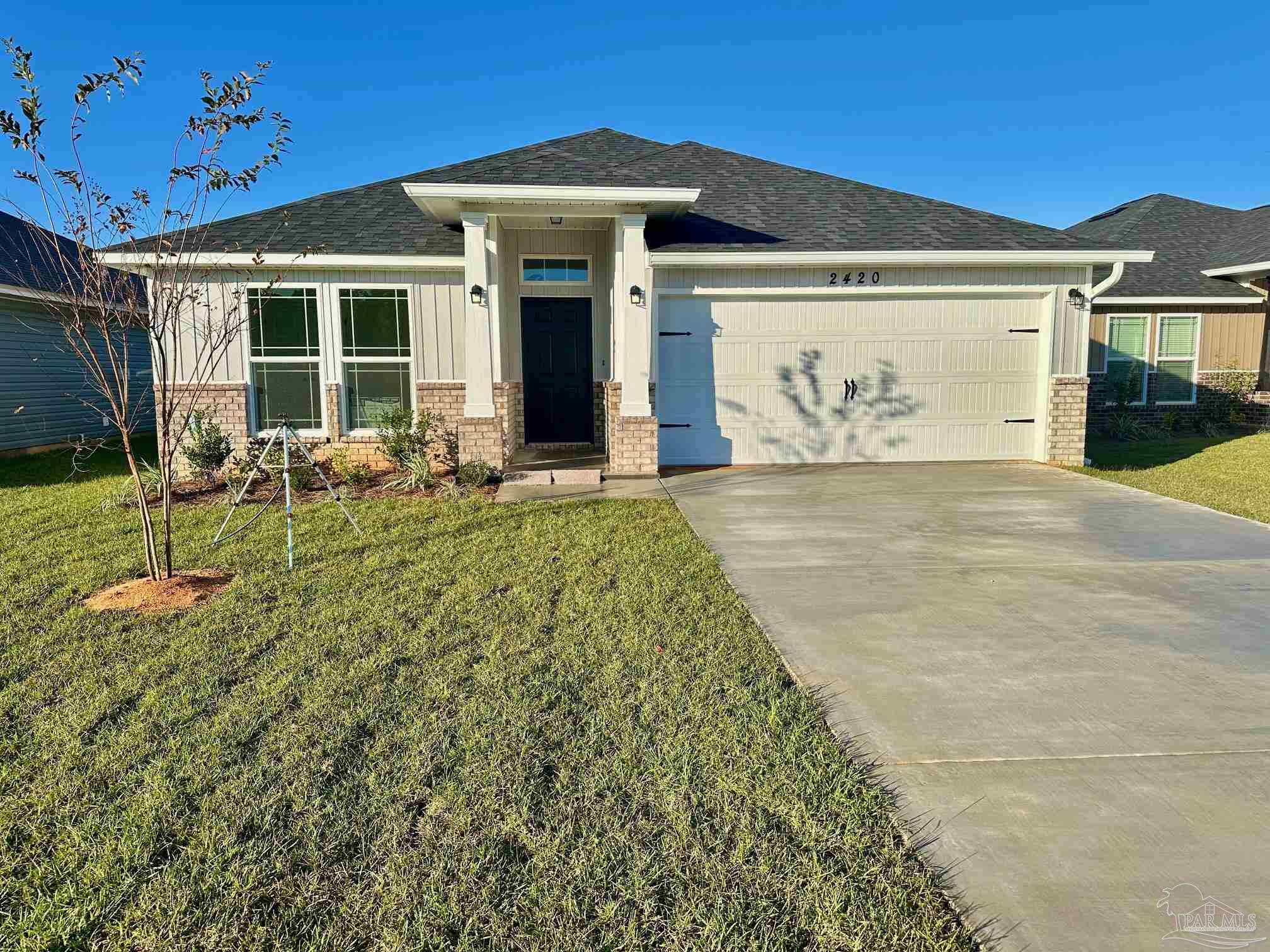 a front view of a house with a garden and entryway