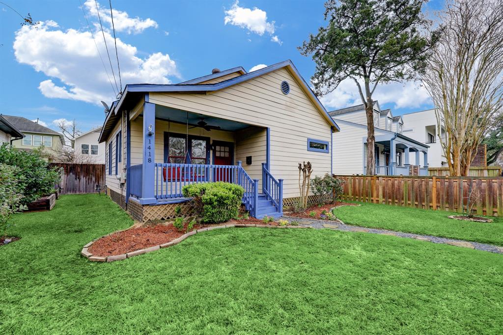 a front view of a house with a yard and porch