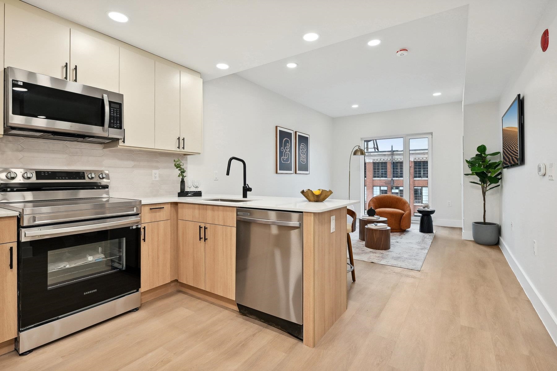 a kitchen with a sink stainless steel appliances and cabinets