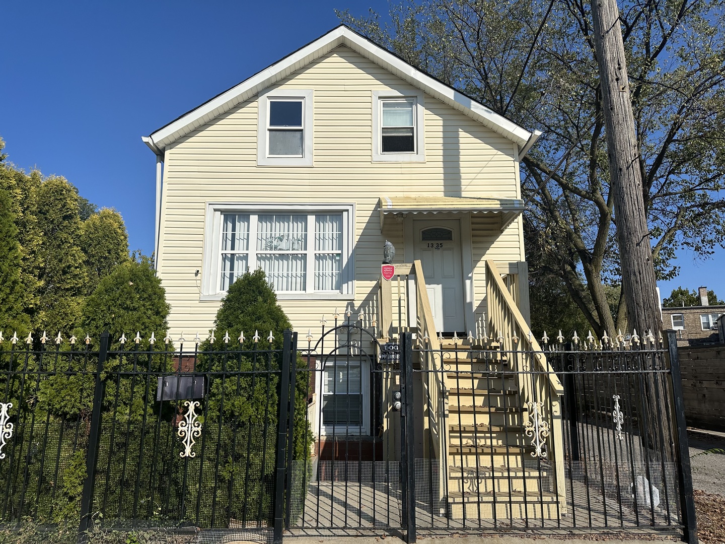 a front view of house along with deck and outdoor seating