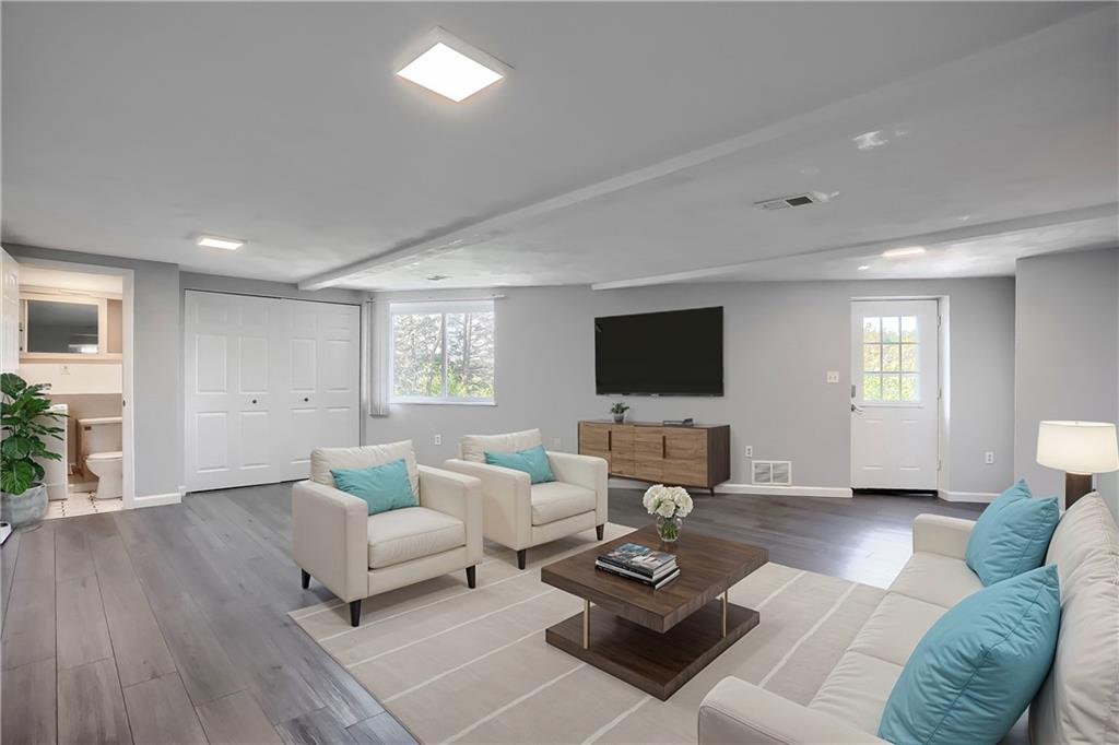 a living room with furniture and a flat screen tv