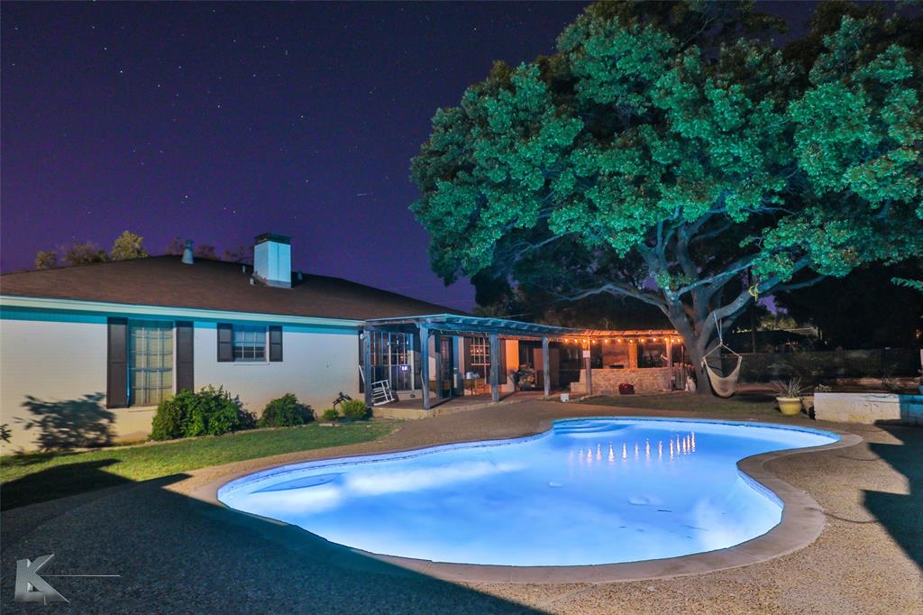 a view of a house with swimming pool yard and patio