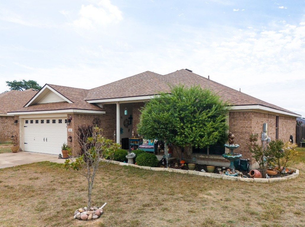 a view of a house with backyard and sitting area