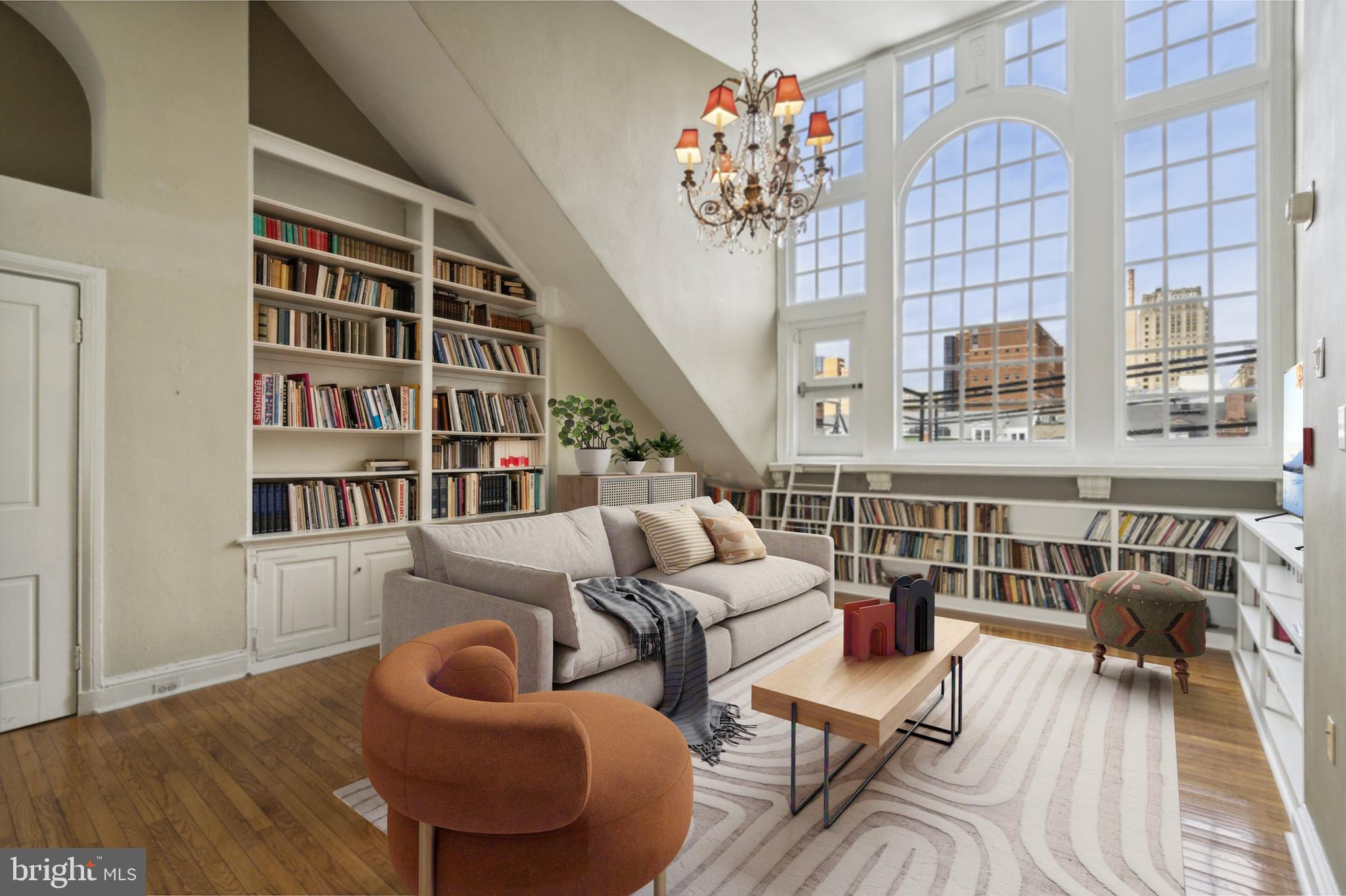 a living room with furniture and a chandelier