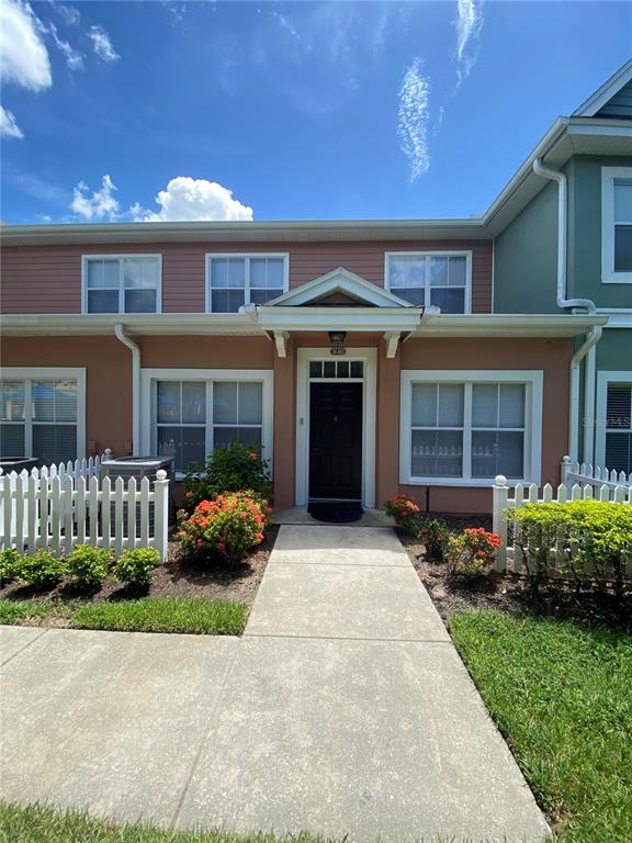 a front view of a house with a yard and outdoor seating