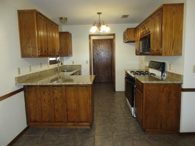 a kitchen with a sink cabinets and stainless steel appliances