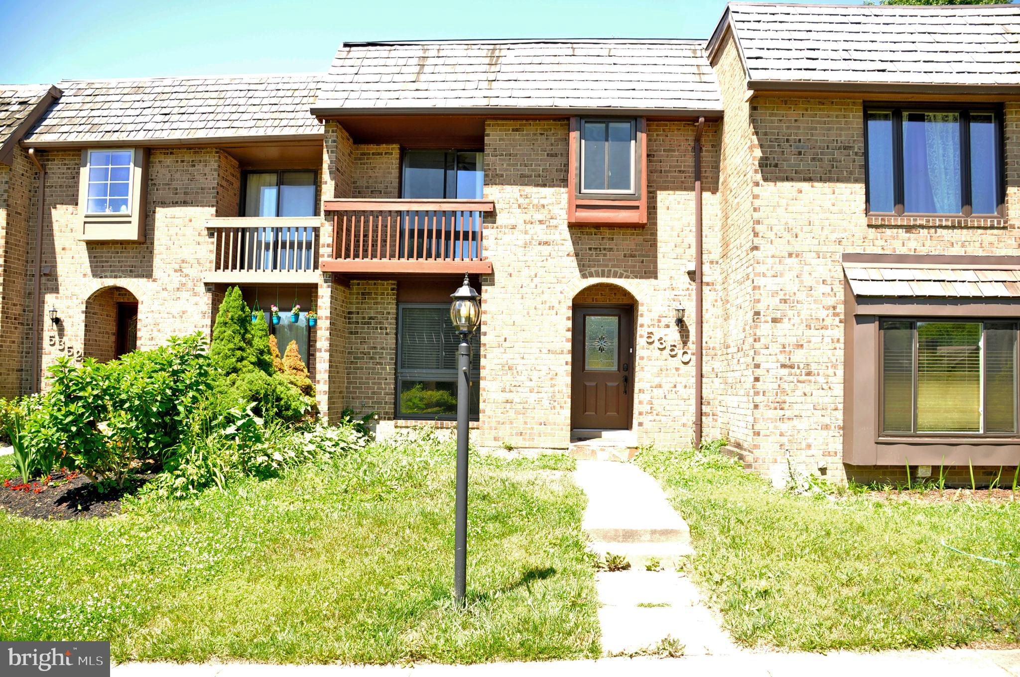 a view of a brick house with large windows