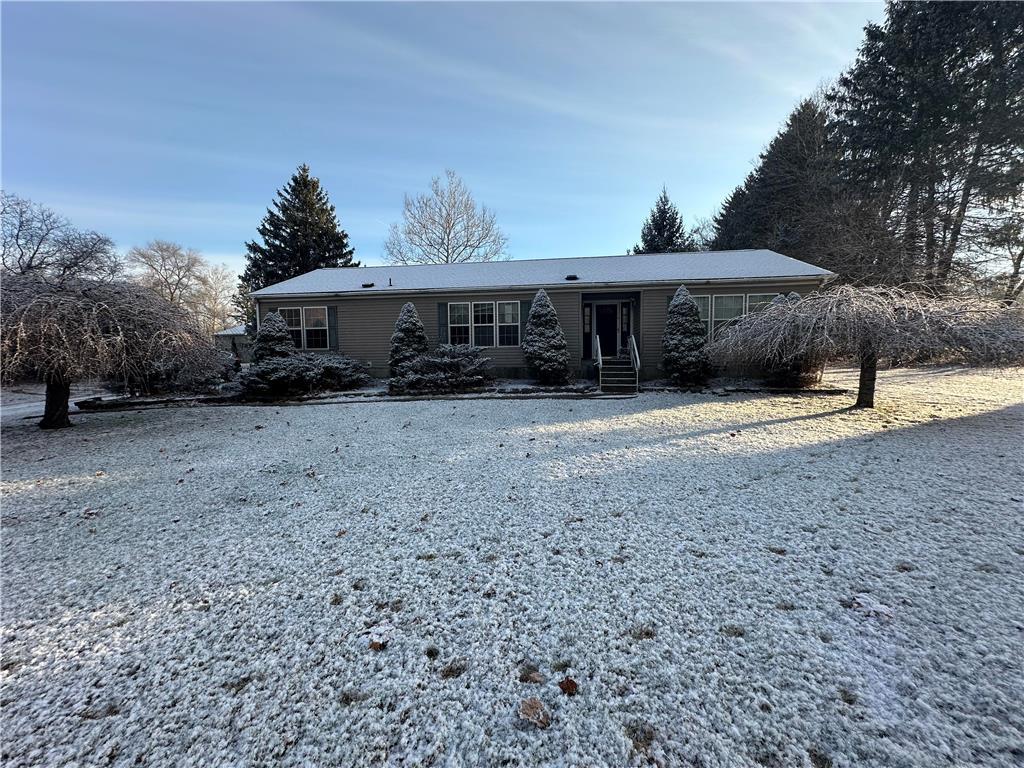 a view of a house with a backyard and trees