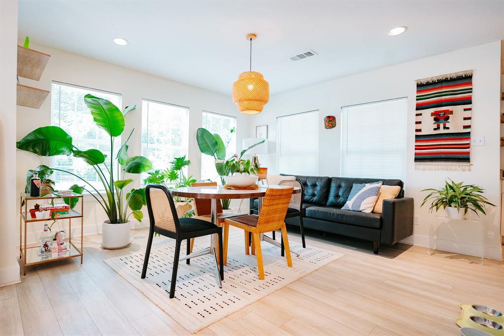 a living room with furniture and a potted plant