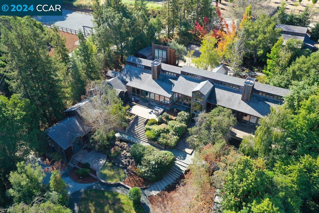 an aerial view of a house with a yard