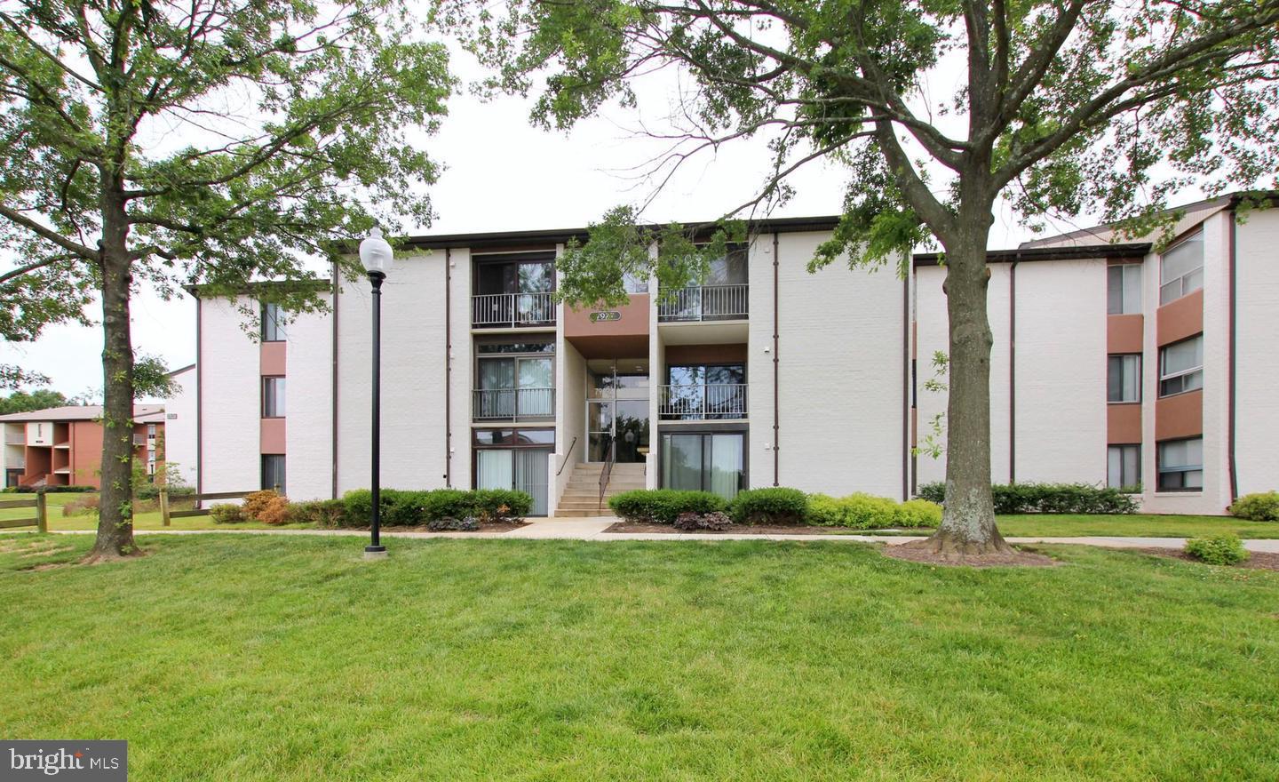 a front view of building with yard