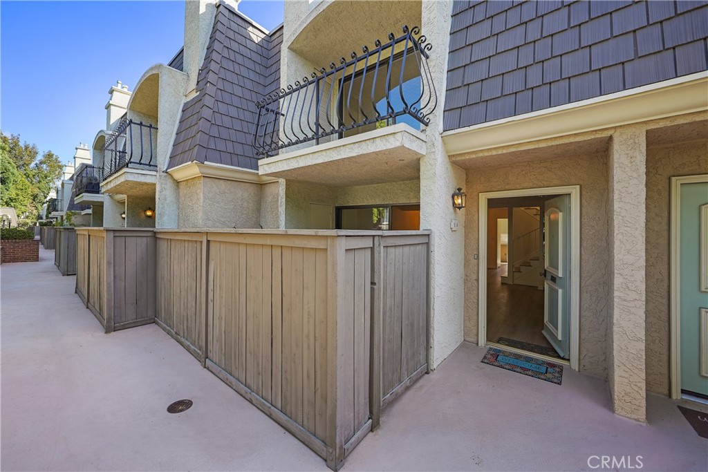 front view of a house with wooden fence