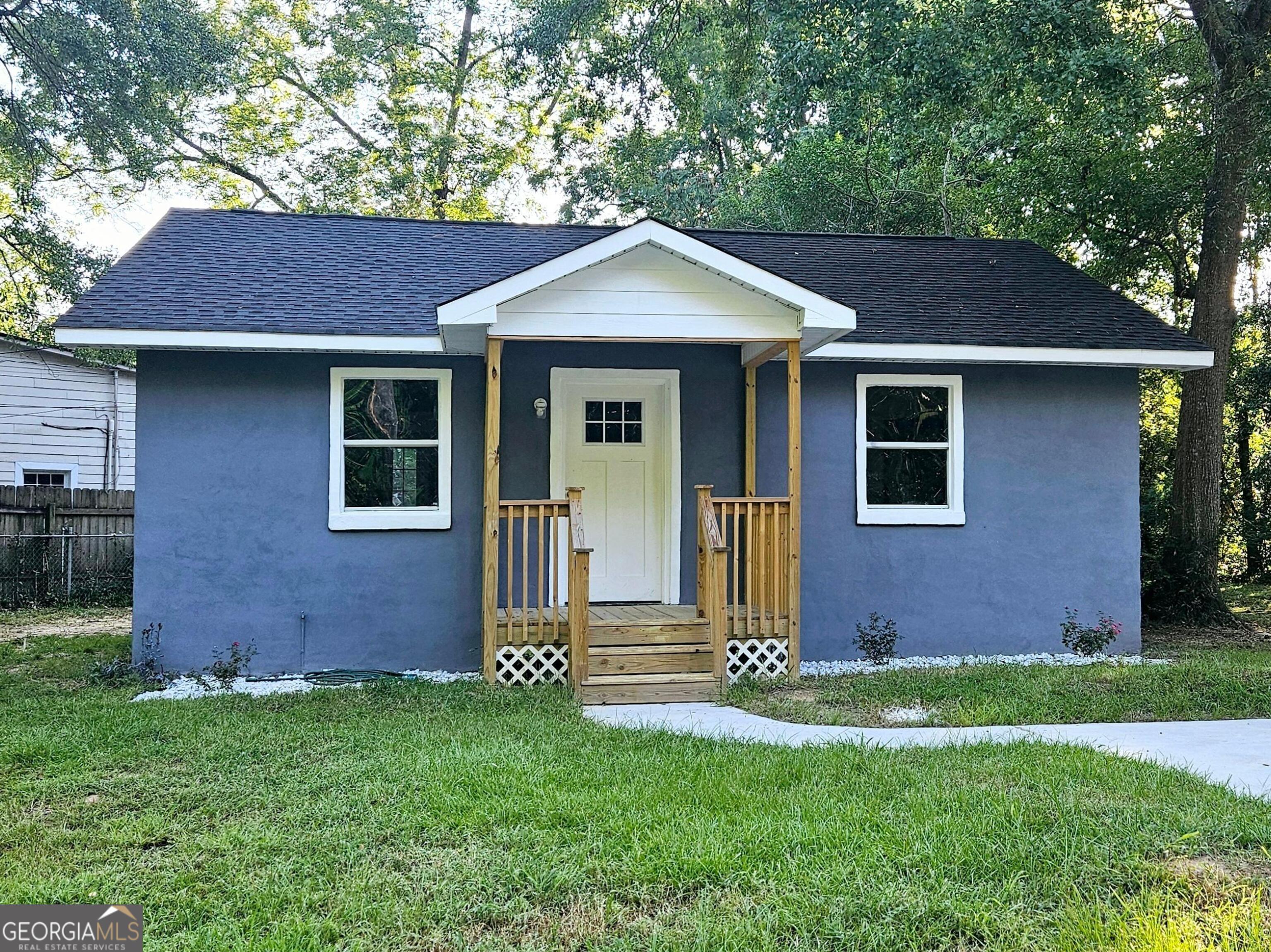 a front view of a house with garden