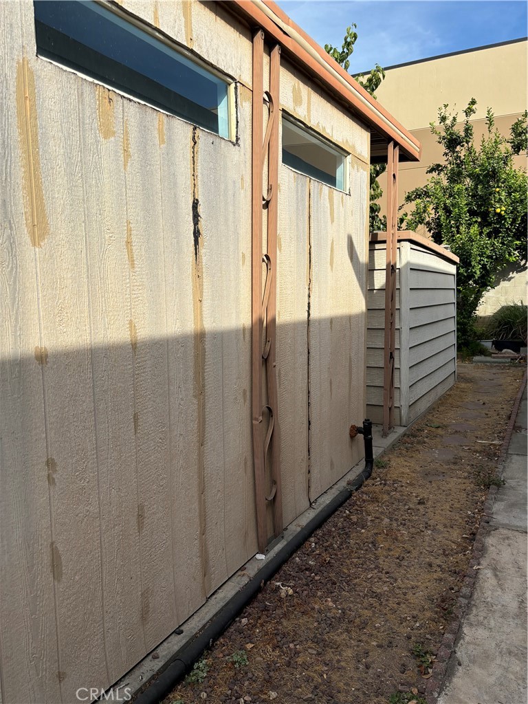 a view of a house with a wooden fence