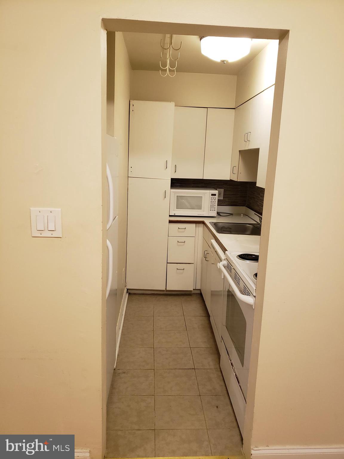 a kitchen with a sink and refrigerator