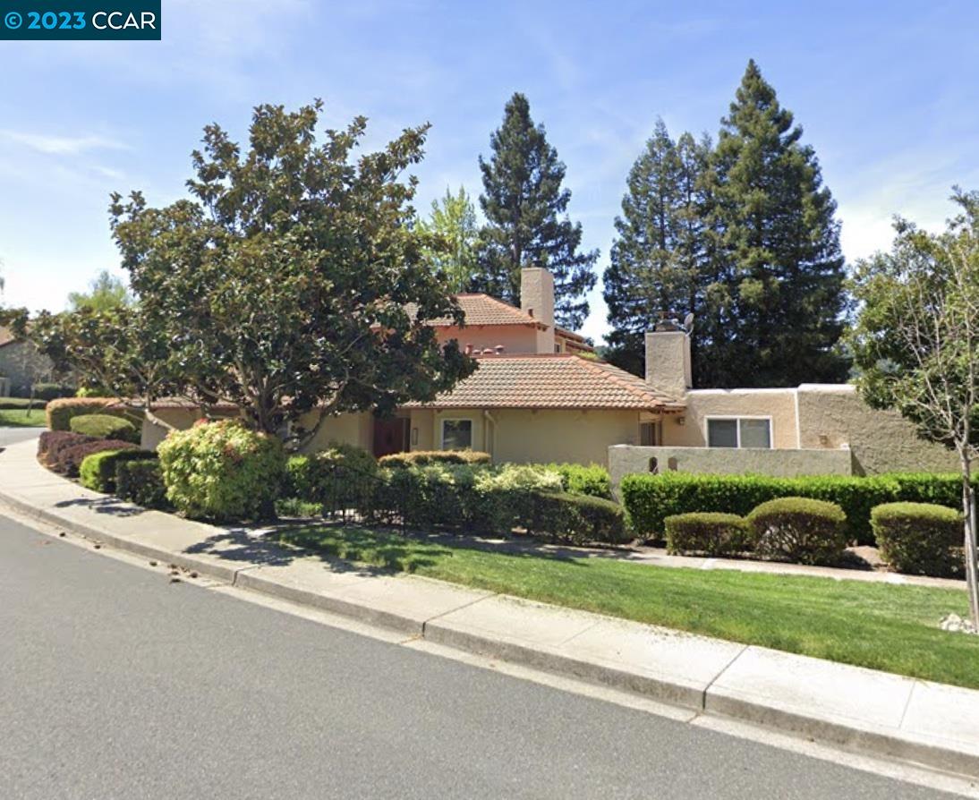 a front view of a house with a yard and a garage