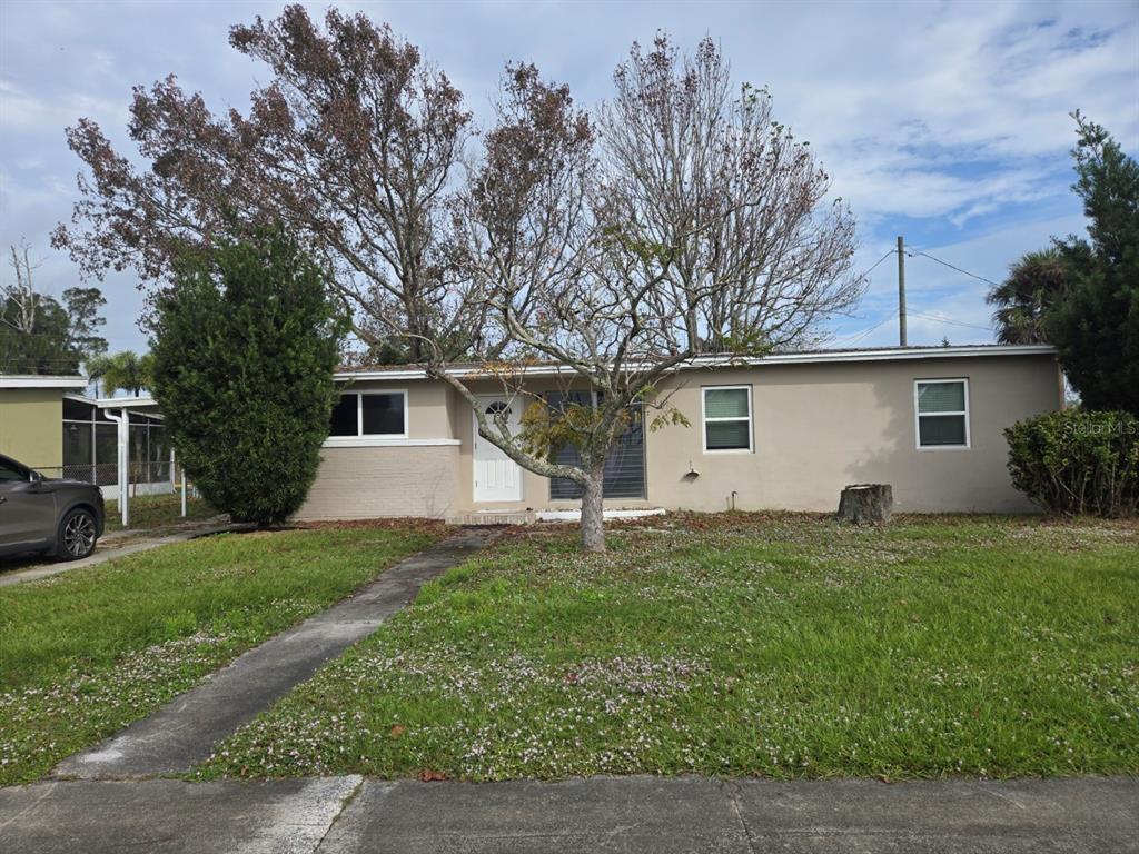 a front view of house with yard and trees