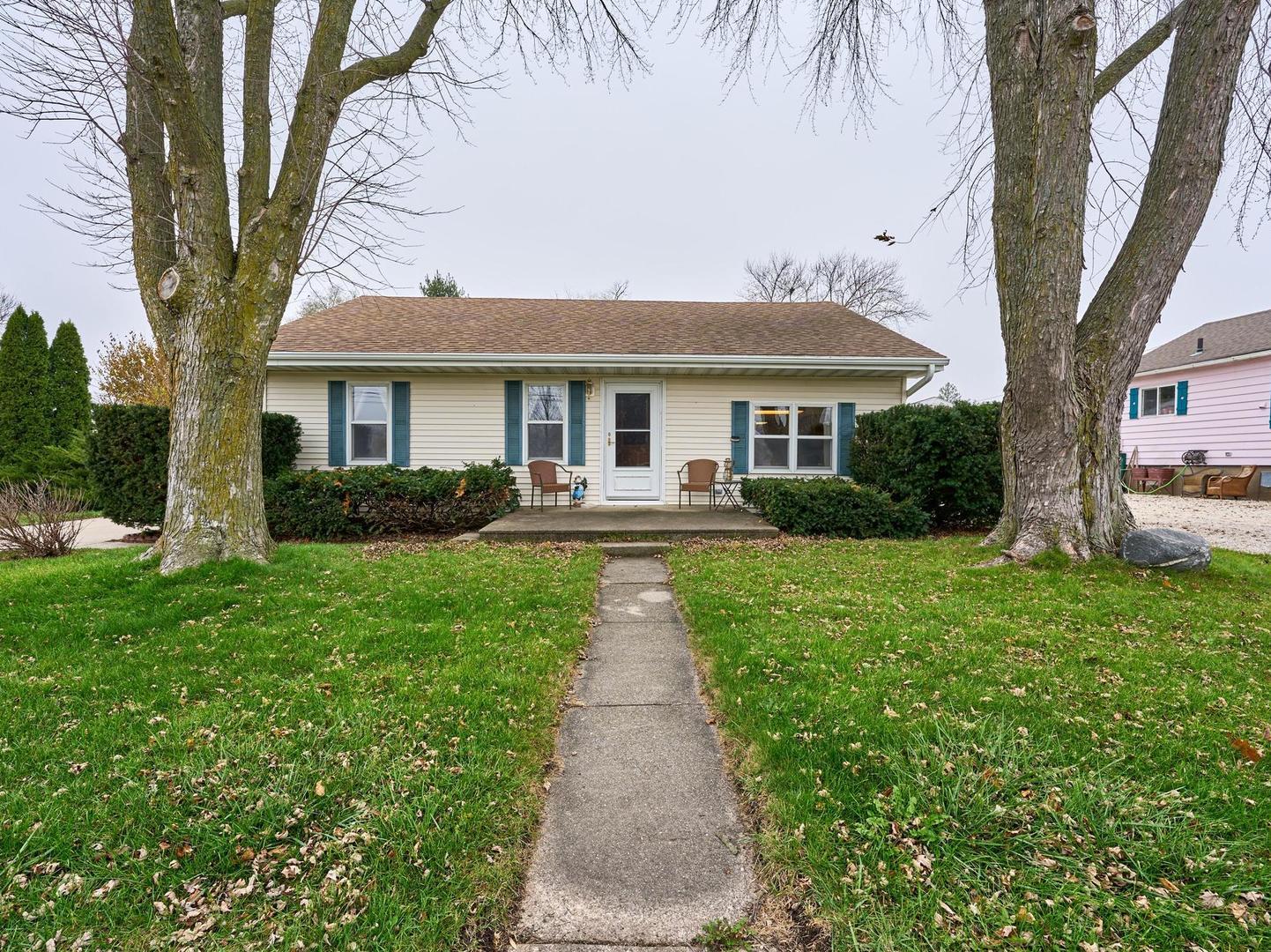 a front view of a house with a garden and patio