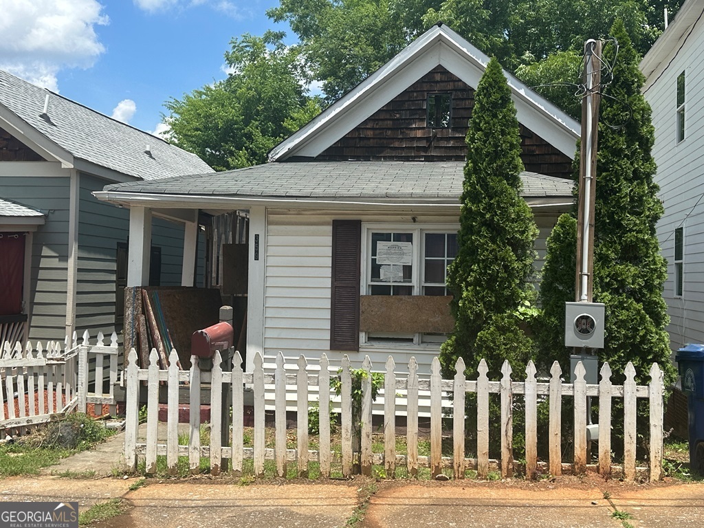 a front view of house with a garden