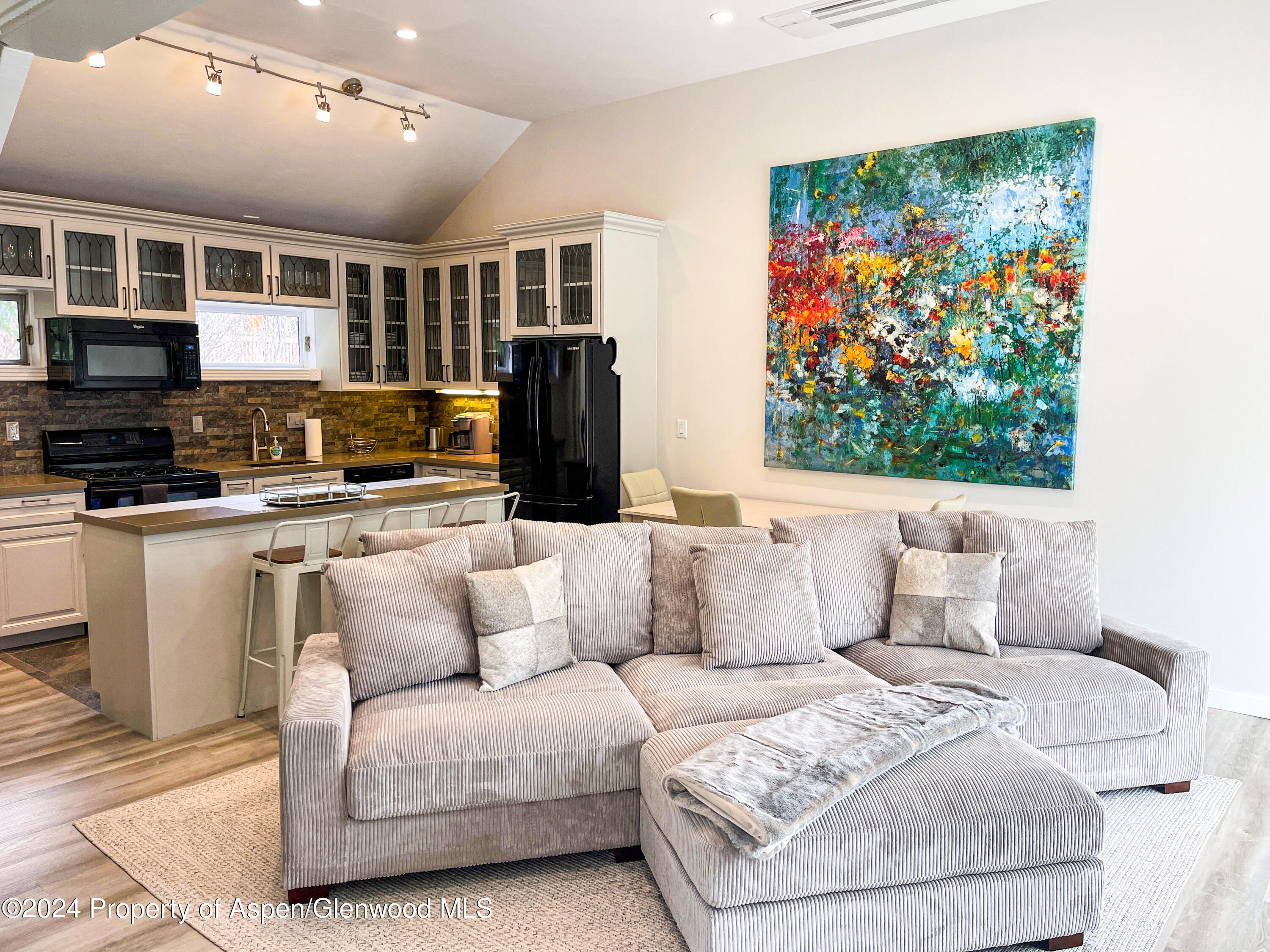 a living room with furniture a flat screen tv and a fireplace