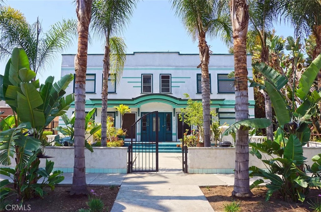 a front view of house with a garden