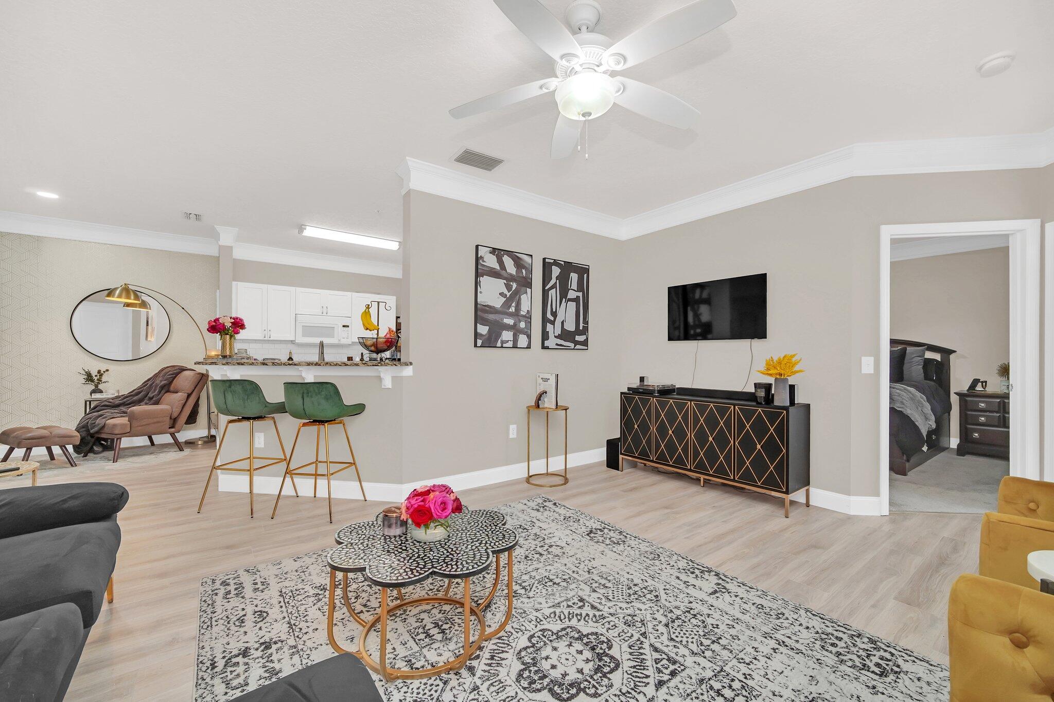 a living room with furniture and wooden floor