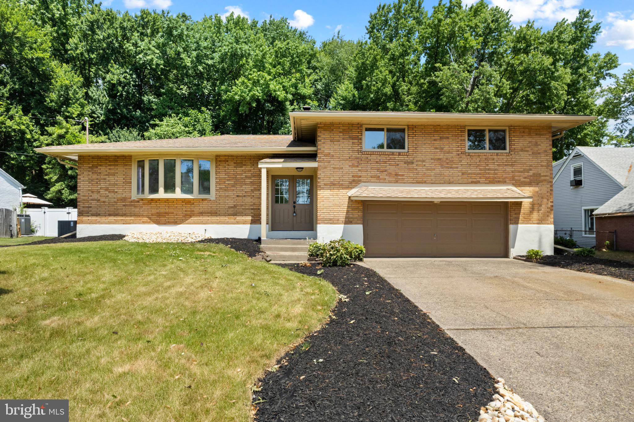 a view of a house with a yard and garage