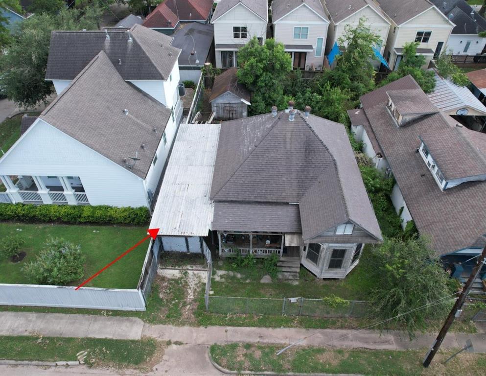 an aerial view of multiple houses with a yard