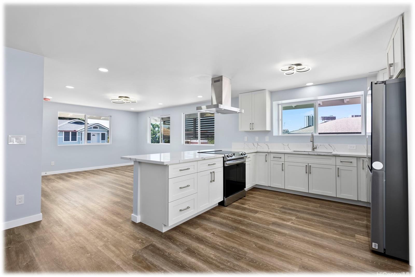 a kitchen with granite countertop a sink cabinets and stainless steel appliances