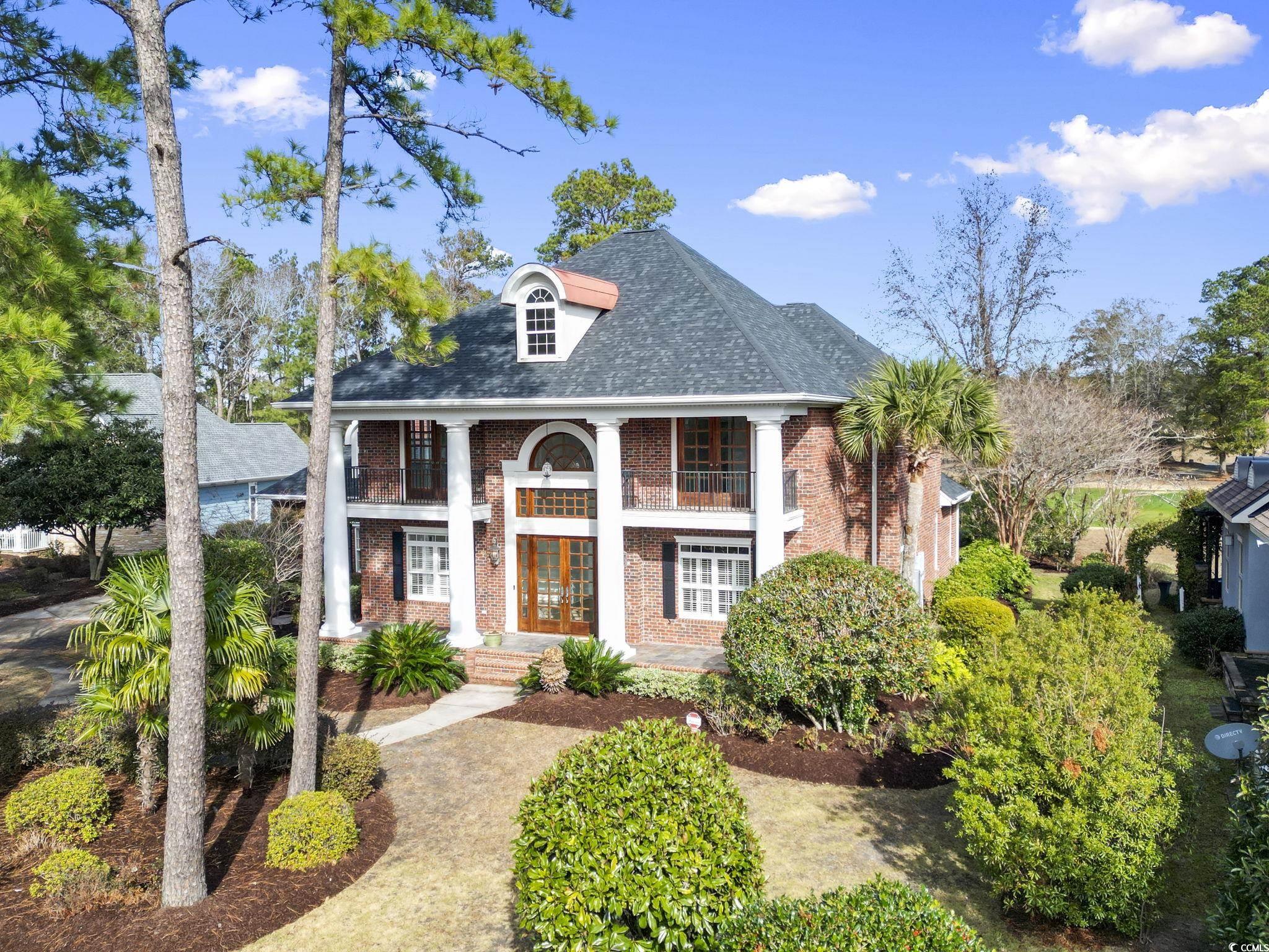 View of front of home with a balcony and french do