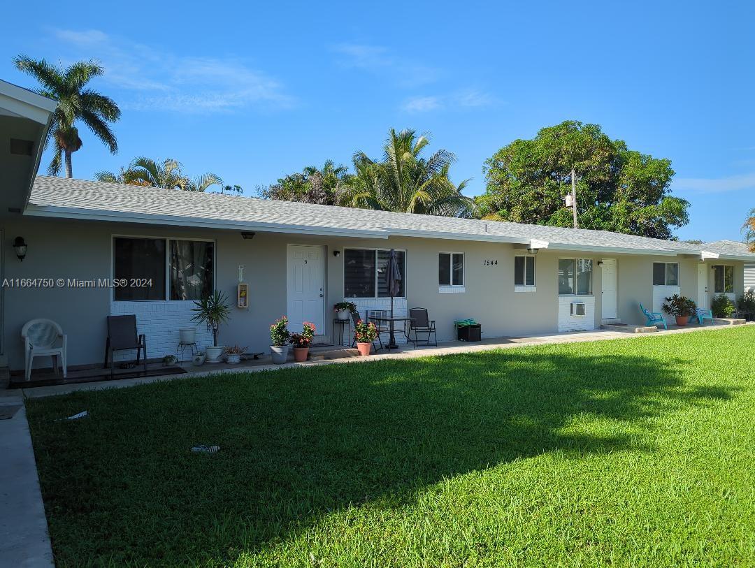 a front view of house with a garden and patio