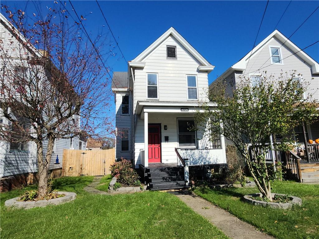 a front view of a house with a yard