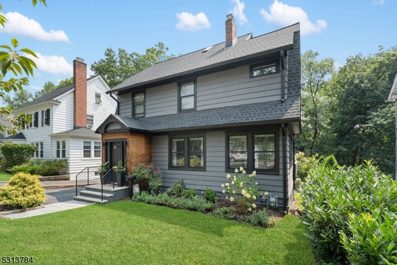 a front view of a house with a garden