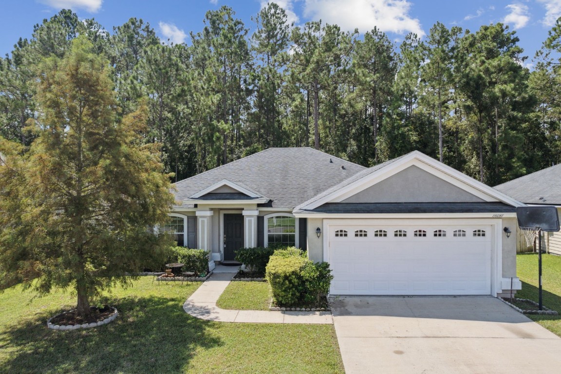 a front view of a house with a garden and yard